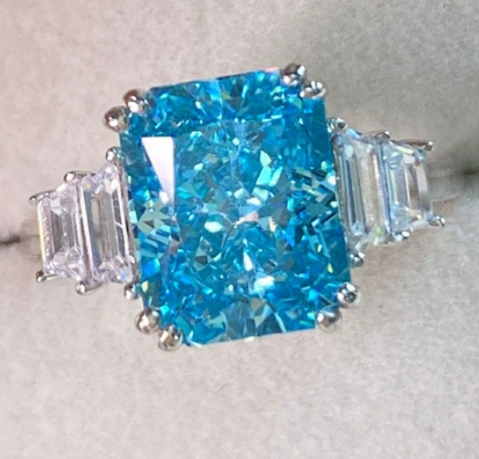 JLUXS Adorable Ladies White Gold Rhodium Over Sterling Silver Created Swiss Blue Topaz & Created Diamond Ring